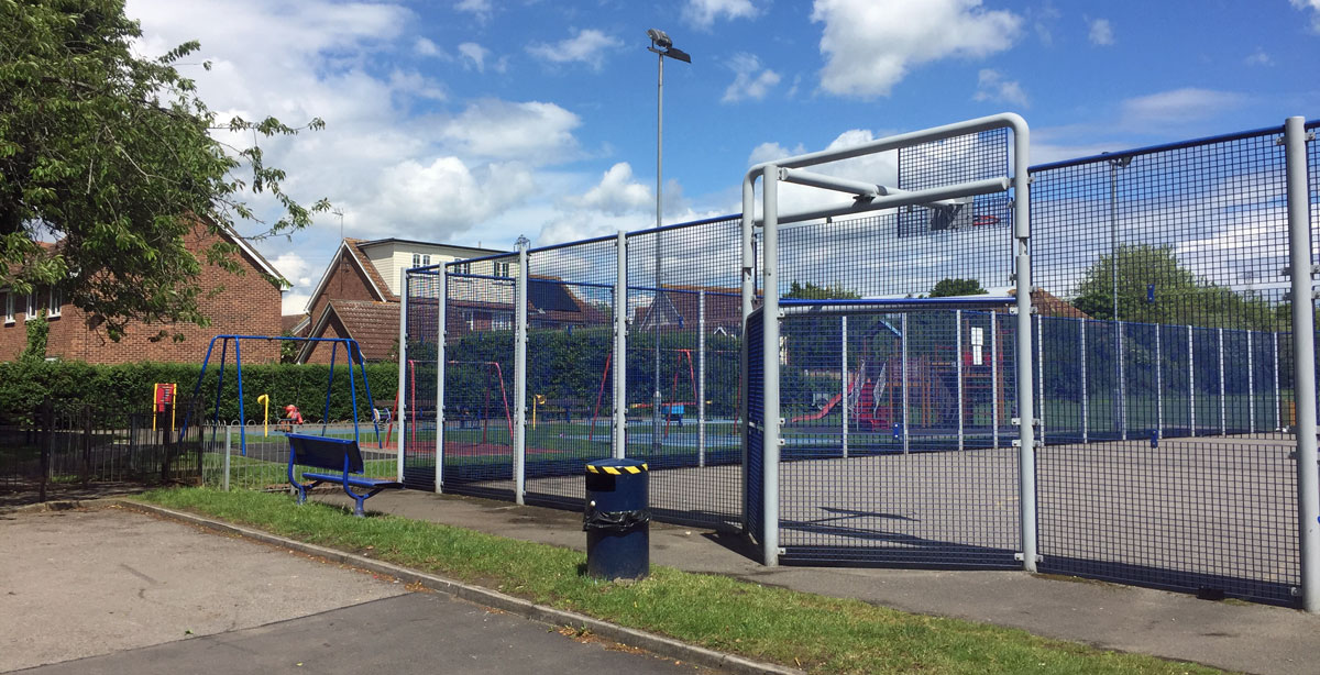 Blue cage for ball games nect to the Village Hall